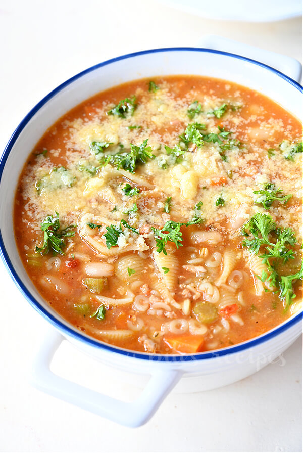 a white pot with pasta e fagioli soup