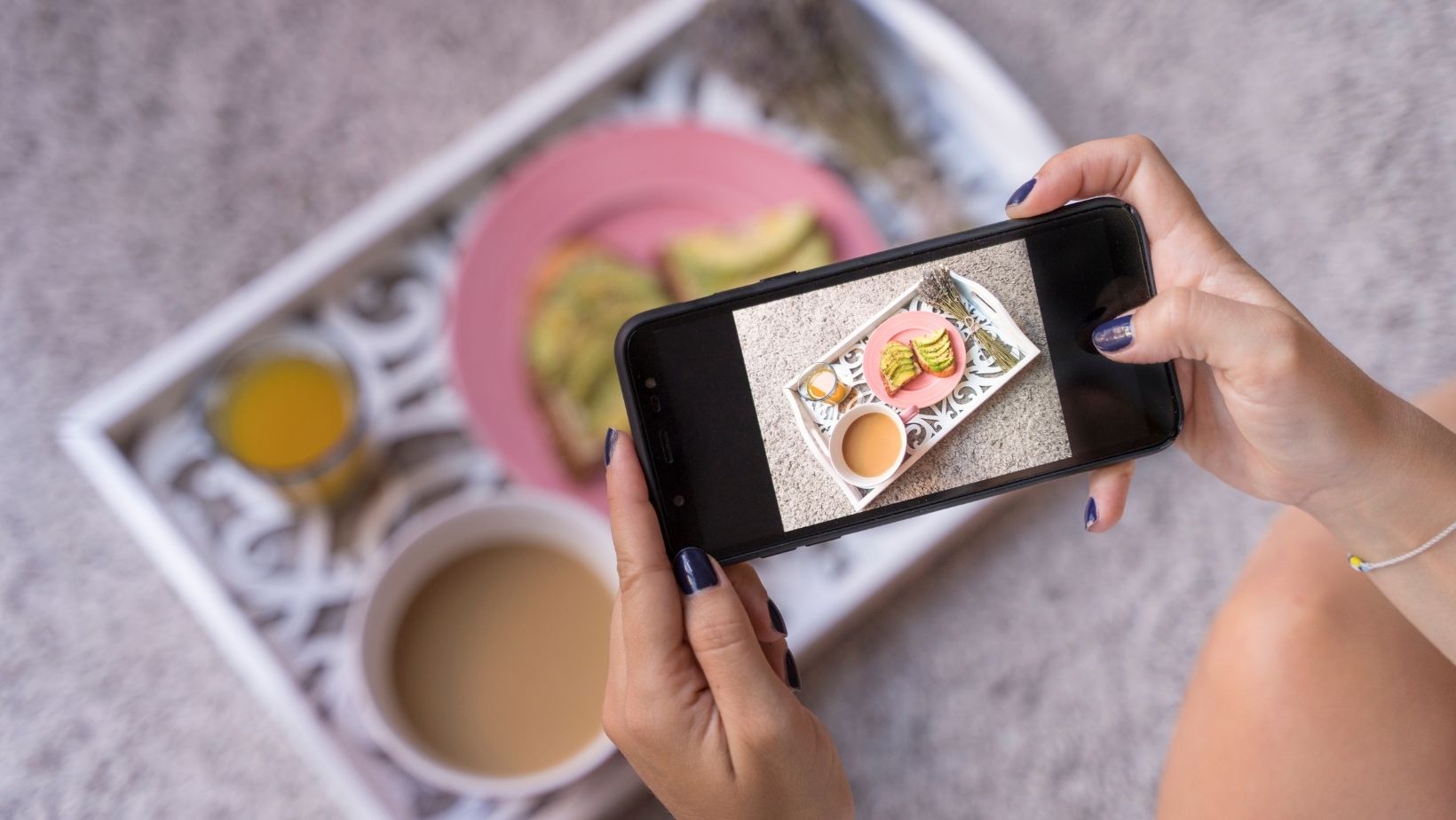 Stock Canva image of an influencer taking a picture of food