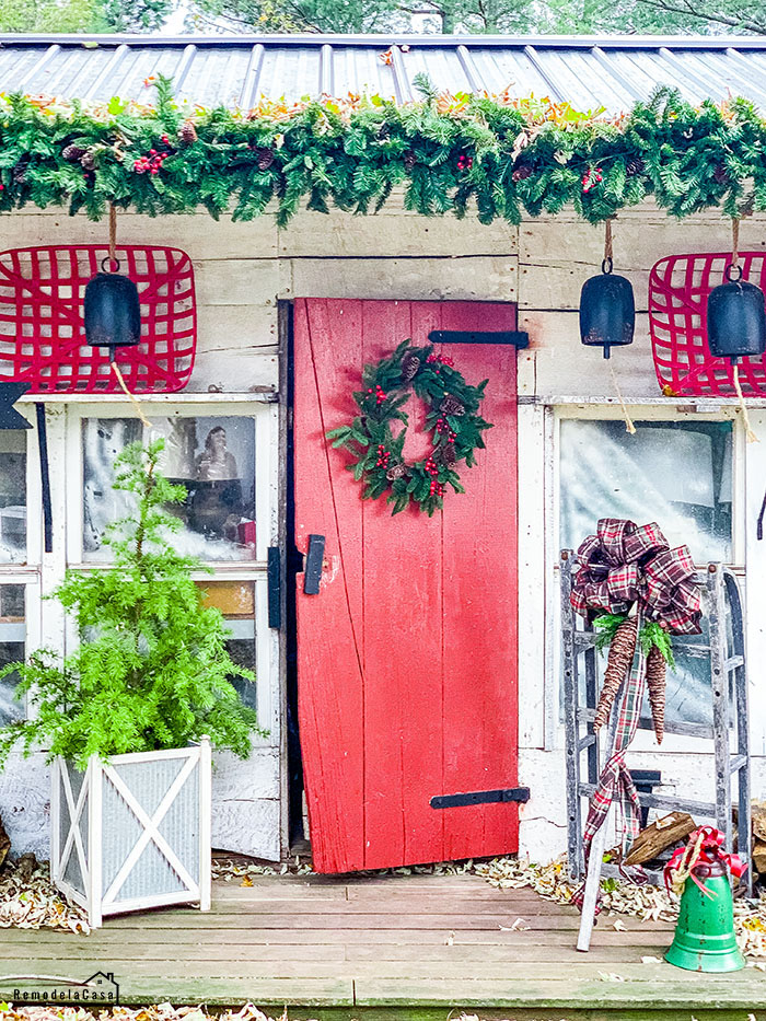 red door with Christmas wreath on cottage