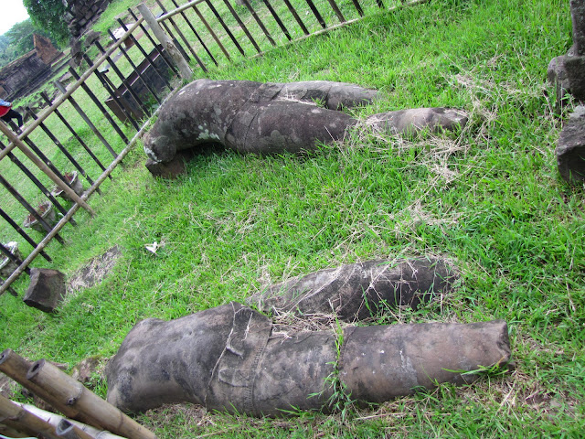 fallen dvarapala guardian statues vat phou wat phu laos