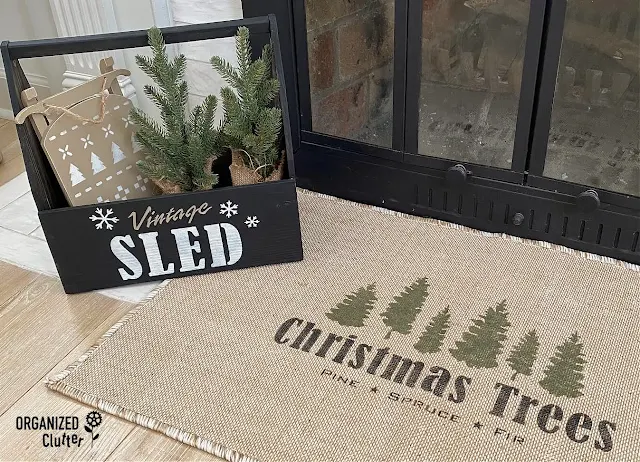 Photo of a jute rug, new with tag, from the thrift store stenciled with Christmas Trees stencil from Old Sign Stencils.