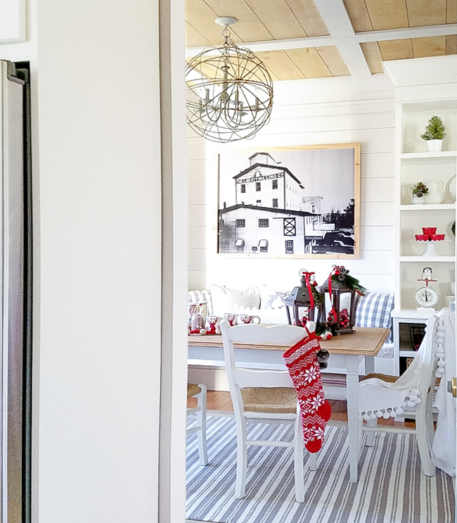 stripped grey and white rug, planked wall and bench