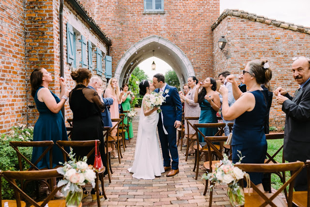 bride and groom kissing by archway at casa feliz