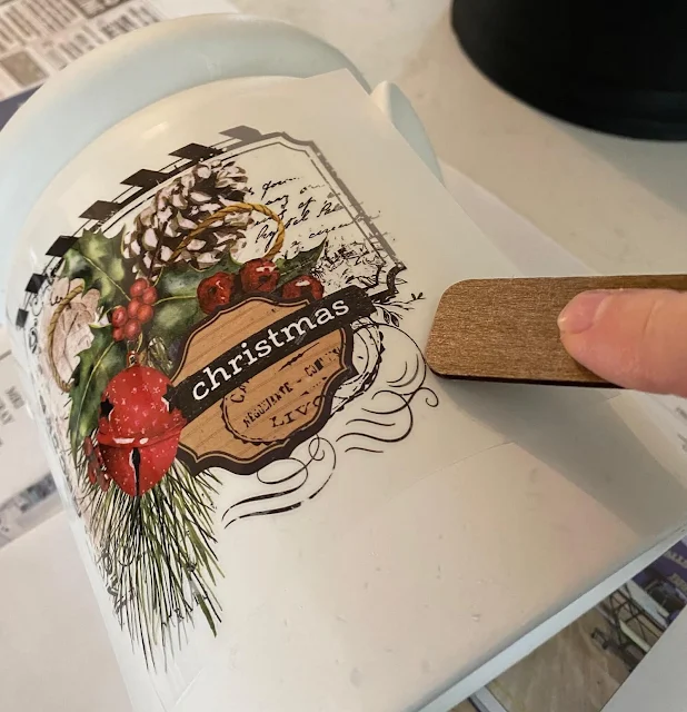 Photo of a decor transfer being applied to a crock.