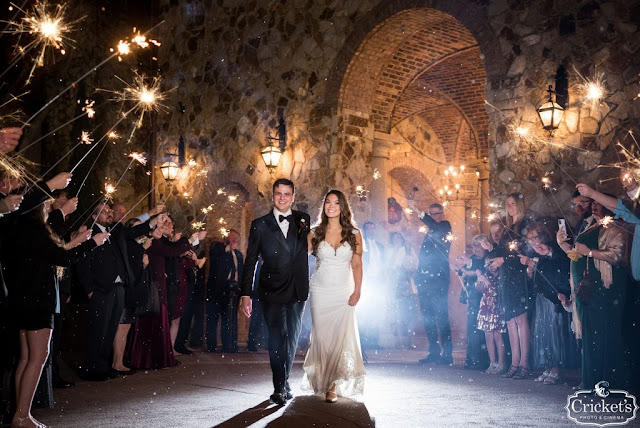 bride and groom walking through sparkler exit at bella collina