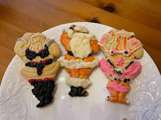 Three Santa Claus-shaped cookies on a white plate: two are obscene