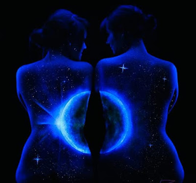 Two women their bare backs made into a backlit moon with starts and a midnight background