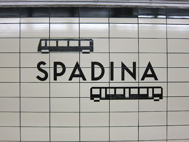 The station identification at Spadina (Bloor) features playful and unique bus and subway icons, which aren't found at any other station. The icons were added via sandblasting in 1978.