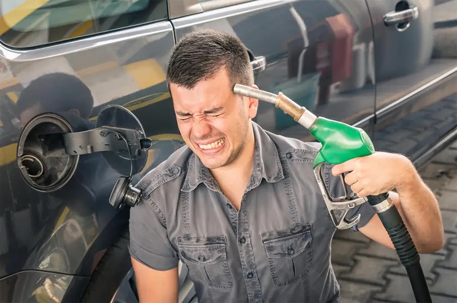 Un uomo alla pompa di benzina