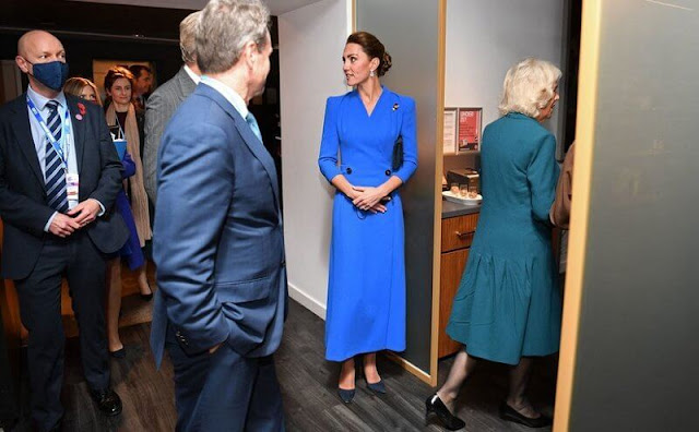 Kate Middleton wore a blue coat dress by Eponine. The Duchess of Cornwall wore a teal dress by Bruce Oldfield