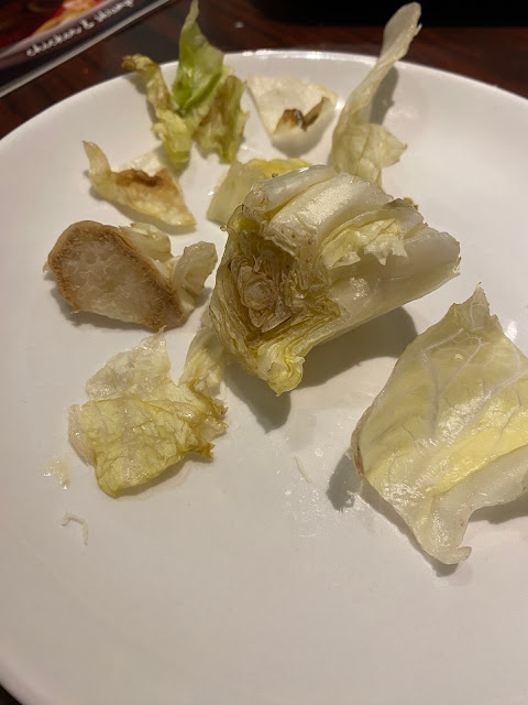 spoiled romain lettuce on a plate