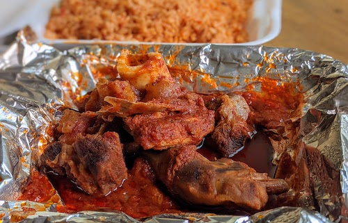 Closer look at mixed meats included with jollof rice