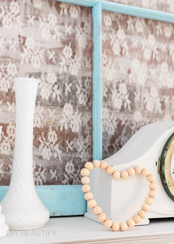 wood bead heart on mantel with vintage window, mantel clock, milk glass