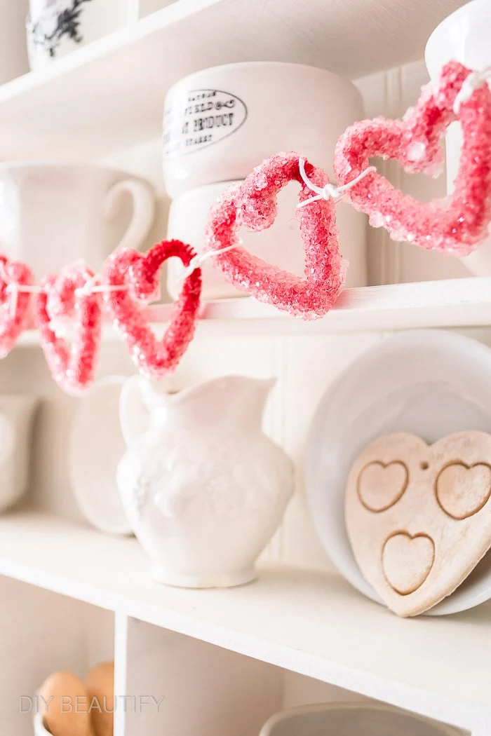 red crystal hearts hanging on display cabinet