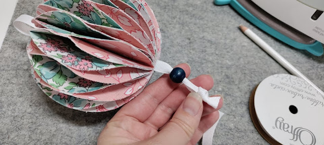Adding ribbon to make a fabric ornament