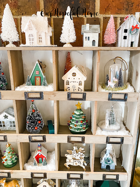 white Putz house snow covered roof white bottle brush tree