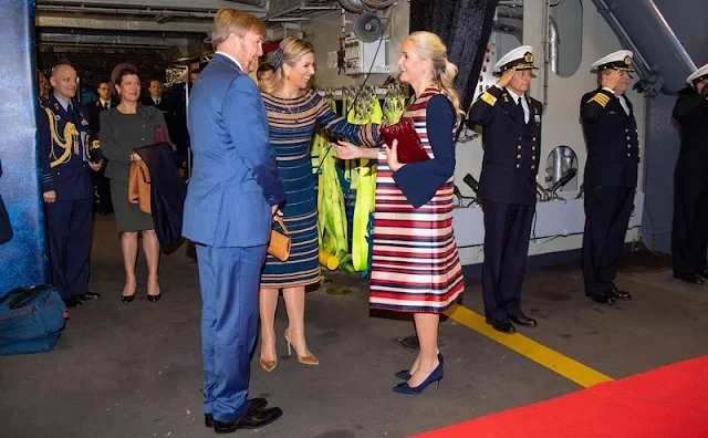 Crown Princess Mette Marit wore a satin stripe sleeveless trench coat by Tome. Queen Maxima wore a navy and beige dress by Jan Taminiau
