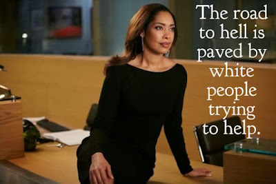 Gina Torres sitting on desk looking serious with the caption The road to hell is paved by white people trying to help