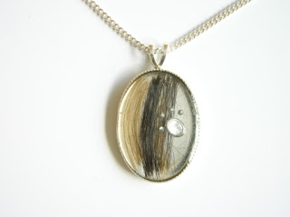 Resin pendant with brindle coloured hair
