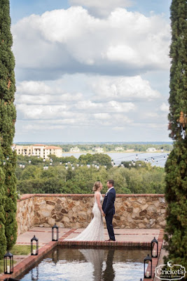 bride and groom holding hands at bella collina reflection pool