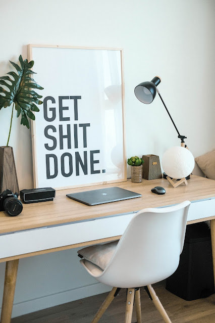 desk with sign, get sh__ done