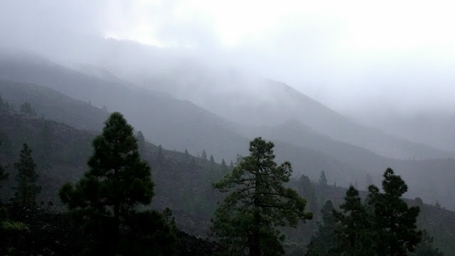 Setting off from Mirador de Chirche at dawn in drizzle as cloud drifts across the jills