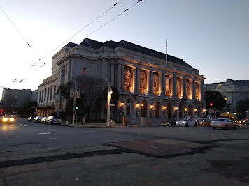 Photo of exterior of the War Memorial Opera House at dusk; the building is a large Neo-classical opera house built in the 1930s.