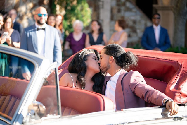 bride and groom in getaway car