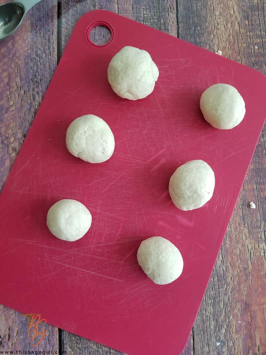 Balls of dough of cassava dumplings waiting to be flattened.