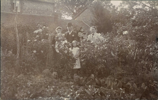 Group of people behind some flowers