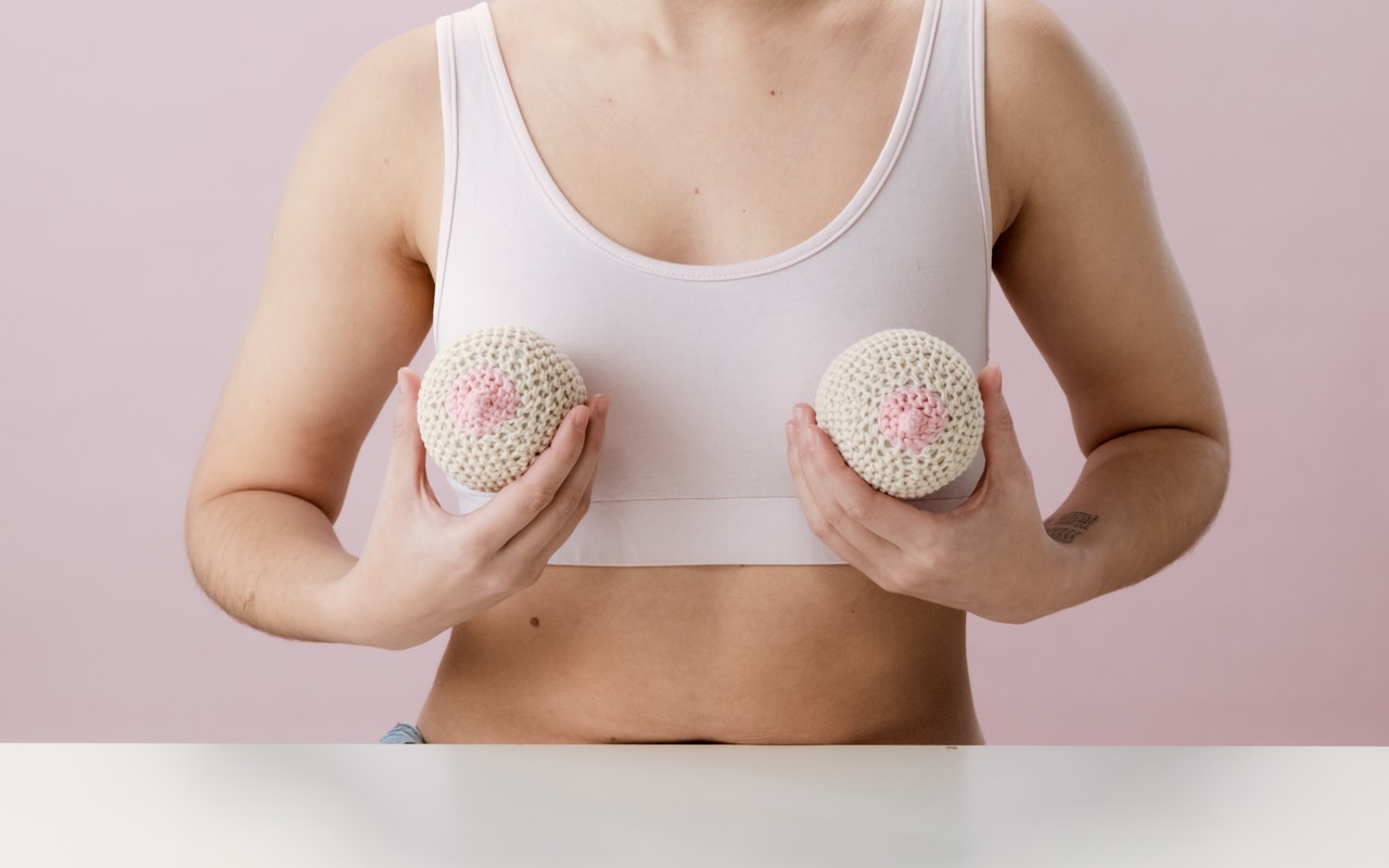 woman-in-white-tank-top-holding-white-and-pink-ball. Girl hitting puberty