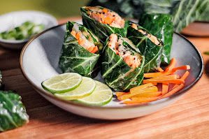 Collard green wraps with salmon on a plate