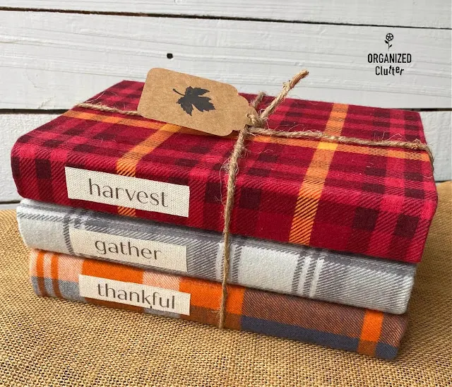 Photo of three thrifted books covered in fall plaid fabrics.