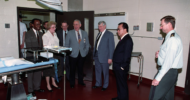 VIP guests are led on a walking tour of the university, including Senator Daniel K. Inouye (pictured second from right), namesake of USU's Graduate School of Medicine.