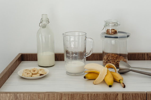 Table with milk, banana and smoothie prep