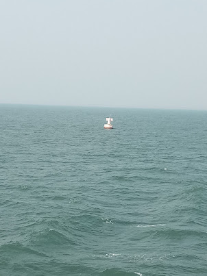 Passing alongside a Indicator Buoy at sea exiting Kochi harbour.