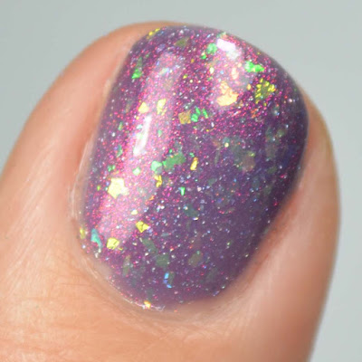 glowing purple nail polish with color shifting flakies swatch