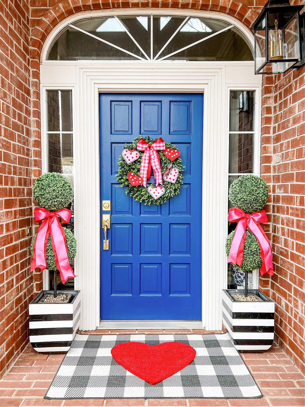 Valentine's Day decorations for front porch- faux boxwood topiaries and heart doormat rug with heart wreath