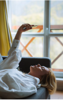 girl using mobile on bed