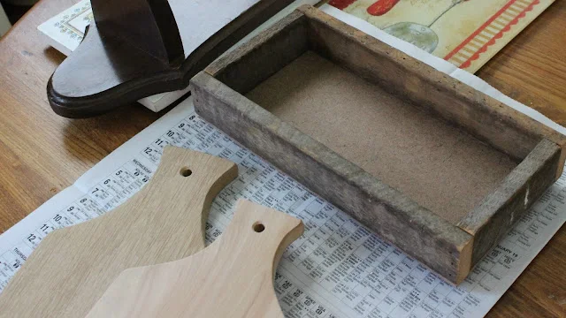 Photo of a small wooden crate and two cutting boards.