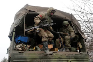 Service members of pro-Russian troops seen in a truck in the separatist-controlled region of Donetsk [File: Alexander Ermochenko/Reuters]