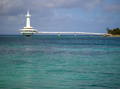 white metal observatory tower on the sea.