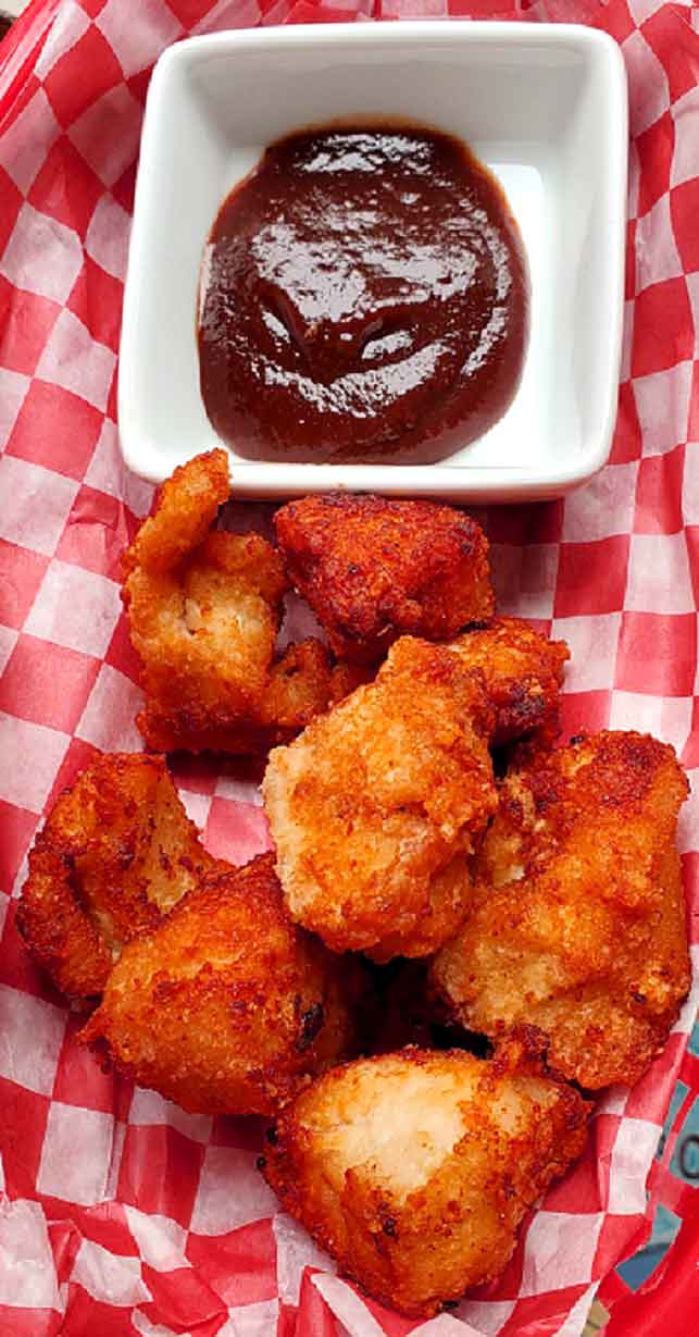 chicken nuggets on checkboard red paper and barbecue sauce