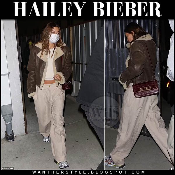 Hailey Bieber in brown shearling jacket and beige trousers