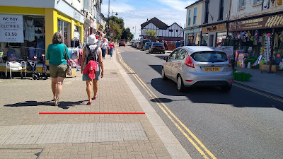 People walking side by side on a footway with a 2 metre width shown by a red line