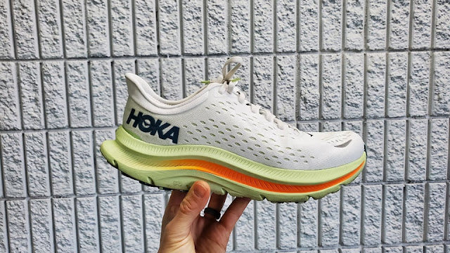 The Hoka Kawana in hand. A white upper with a yellow CMEVA midsole new to Hoka..