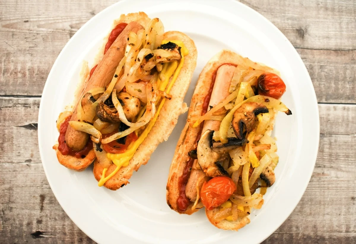 Easy Vegan Hot Dogs in buns stacked with toppings