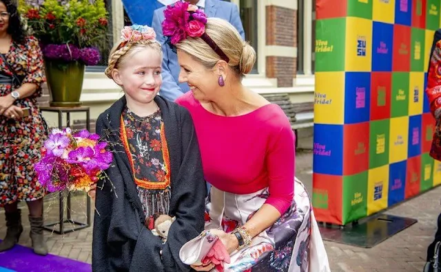 Queen Maxima wore a fuchsia blouse and floral print midi skirt from Natan. Mexican painter Frida Kahlo