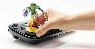 a Link Super Smash Bros. amiibo put on the Wii U GamePad by someone's hand