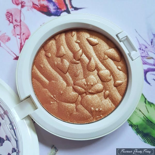 open round compact with rippled bronze highlighter powder with floral embossing